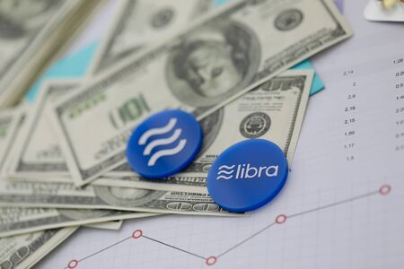 Libra blue cryptocyrrency coin lie on tableの写真素材