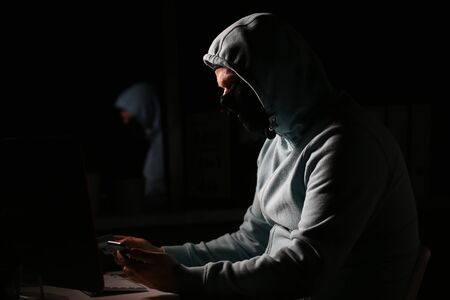 Man carder in mask connect to darknet search information bank system pc crack dark web uses stolen...