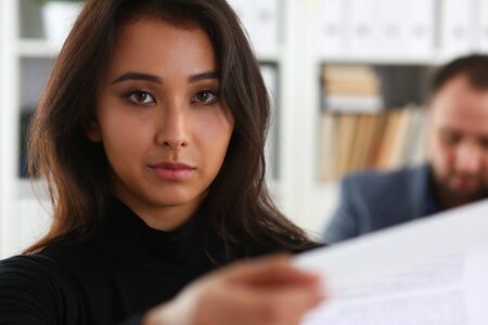 portrait of young brunette business lady study documents paper work conceptの写真素材