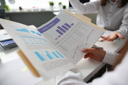 Group people hol business chart in hand on seminar. Financial education concept. Statistic tax form reportの写真素材