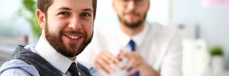 Group of smiling bearded businessmen in suit and tie at office workplace portrait. Positive emotion worker corporate staff dress code style profession coach training visit job offer ideaの写真素材