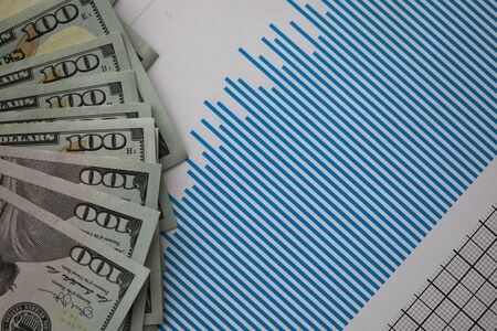Close-up of money banknotes and important statistics documents with graphs. Planning and growth...