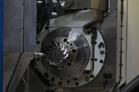 Focus on special workshop utility nested into factory and used for making automobile details out of...