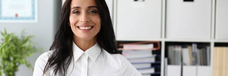 Business woman in white shirt against office background. Business education concept