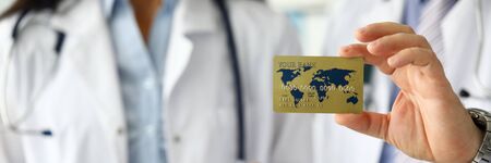 Group of medics presenting to visitor special member card for easy payment close-upの写真素材