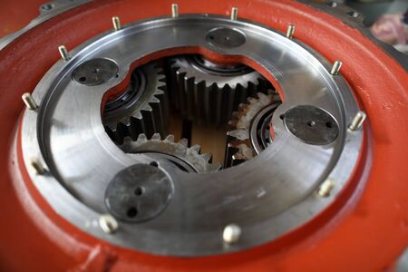 Big mechanical gear part with set of cogwheels inside close-up