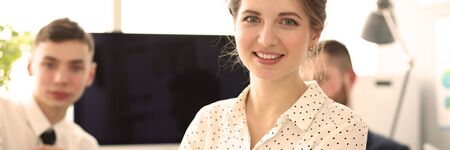 Portrait of gorgeous woman sitting in big modern office and talking with friendly colleagues about important business project or agreement. Company meeting conceptの写真素材