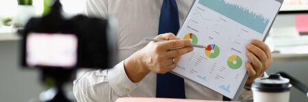 Male hand hold clipboard with business chart closeup. Online workshop broadcast. Webinar for...