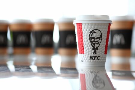 Minsk, Belarus - September 26, 2019: KFC cardboard cup standing among pile of mcdonalds cupsのeditorial素材