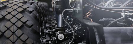 Close-up of new suspension system and shock absorber of car with wheel. Automotive part of atv off...