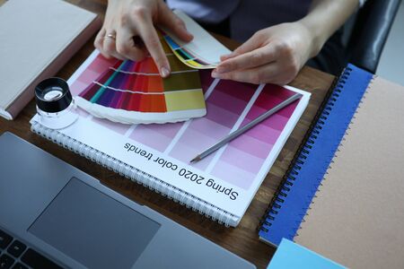 Palette 2020 spring lie on wooden office table closeup background. Choice of color solutions for...