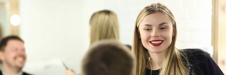 Happy Hairdresser Styling Male Hairdo for Client. Blonde Hairstylist Making Haircut for Man Customer. Woman Barber Working on Hairstyle in Barbershop. Stylist Girl in Professional Beauty Salonの写真素材