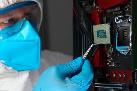 Male engineer install microprocessor in fast computer machine closeup. Modern system database conceptの写真素材