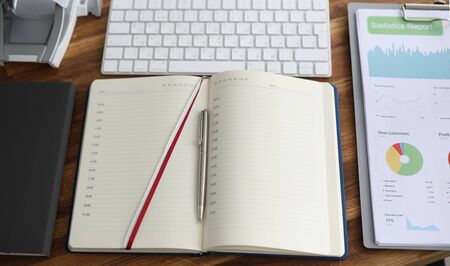 Daily planner, keyboard on desk company employee. Responsible worker table. On it stapler, closed...