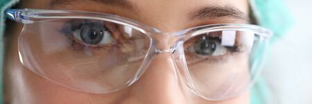 Medical doctor in protectine glasses look at camera facial portrait. Medicine education concept