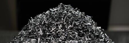 Close-up of pile of metallic shavings made after machinery work on milling or turning lathe for...
