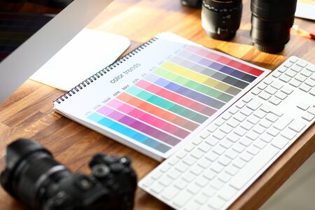 Color calendar book with color trends sign on designer wooden table closeup background. Color proof device conceptの写真素材