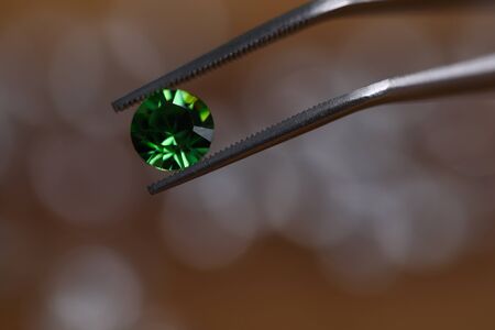 Close-up view of luxury emerald crystal gemstone. Macro shot of polished green diamond. Most precious beauty. Flawless brilliant cut and posh jewelry conceptの写真素材