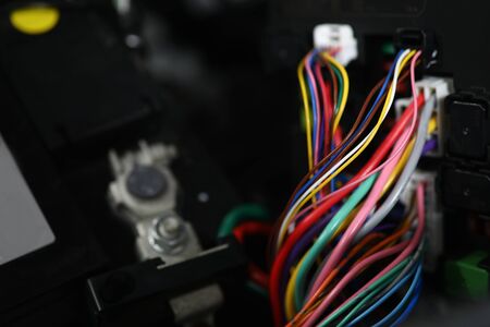 Close-up view of large wide cable with multicolored wires and connectors. Electric connector plug of...