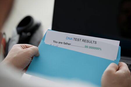 Man received letter in envelope with dna test for paternity. Unwanted child concept. Medical genetic researchの写真素材