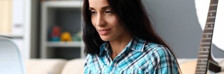 Portrait of charming lady learning to play modern synthesizer. Talented composer composing melody....