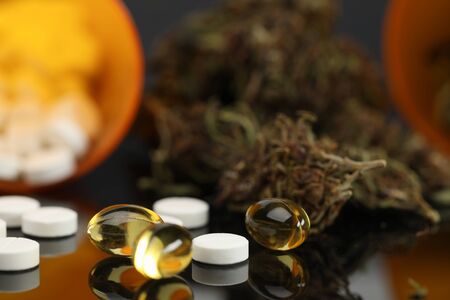 On table are hemp tablets and vegetable capsules. Wide range cannabis products with varying levels essential psychoactive substance. Reliable product information. Intensity effect when usedの写真素材