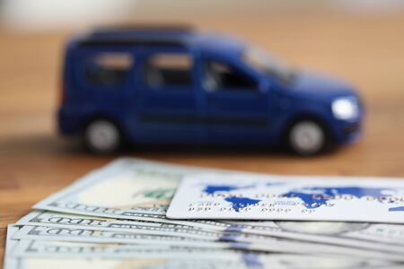 Close up dollars and credit card auto background. America car auction. Solving issues related to...