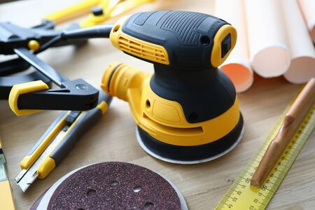 On table lies grinding machine tool for builder. Repair and construction activities and facing...