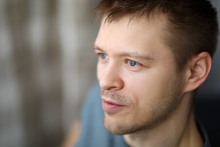 Close-up portrait in profile of an ordinary guy. Appearance young man. Man looks into distance. Calm...