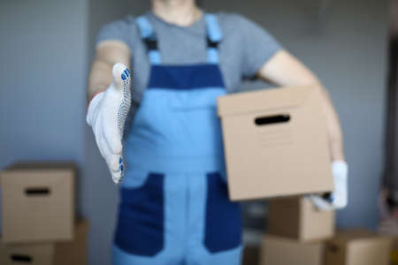 Male hand hold cardboard against new flat closeup background. Fast delivery service concept