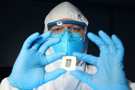 Portrait of scientist in protective costume glasses and face mask. Biochemist in laboratory. Danger...