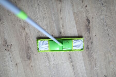 Close-up, mop standing laminate floor disinfection.の写真素材