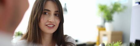 Portrait of smiling designer showing house scheme. Wonderful businesswoman telling about opportunities. Business and art design concept. Blurred backgroundの写真素材