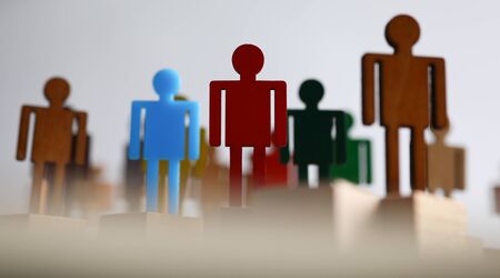 Plastic or wooden colored figures people team. People lost their jobs during pandemic. Office staff in search job. Men change their profession during quarantine. Recruitment crisisの写真素材