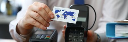 Man shows credit card offers terminal choose. Installation finance terminals, supply communications...