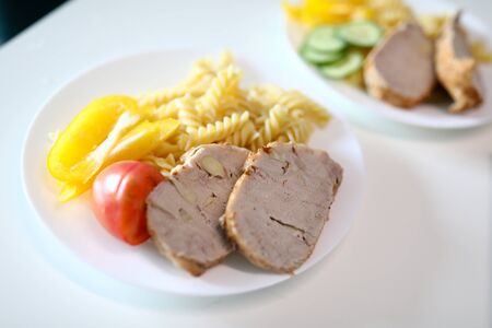 on table are plates food, meat and side dish. videography educational and business events. learn to beautifully serve and serve your culinary masterpieces. Dinner at home in restaurant, feed familyの写真素材