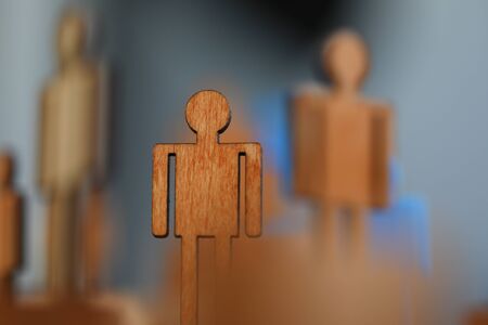 Close-up, wooden mans flat figure, political puppet. Prestigious job for people. Protection labor rights workers. Figures people for presentation wooden and plastic. Manipulative methodsの写真素材