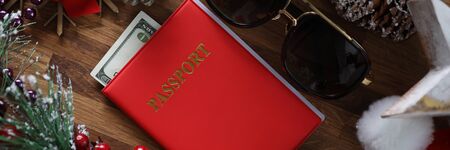 Sunglasses with red passport and sunglasses against xmas bacground. New Year celebration in warm countries conceptの写真素材