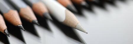 Focus on light writing utility lying on desk slightly closer to camera. Drawing tool symbolizes...