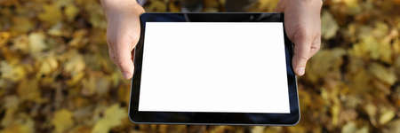 Top view of gadget in male hands. Man holding device with empty copy space on screen. Guy in casual...