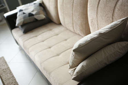 Top view of beige comfortable couch in living room at home. Interior design conceptの写真素材