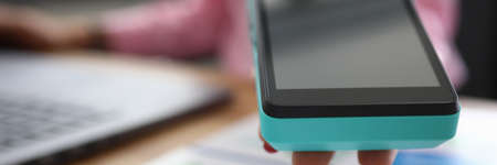 Close-up girl offers portable banking terminal. Cashback card, small percentage purchase is returned to account in form money or bonuses. Installation and terms use trading POS terminalの写真素材