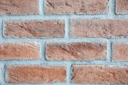 Close-up of red brick wall. Long bricks with cement. Part of construction site. Cropped picture of...
