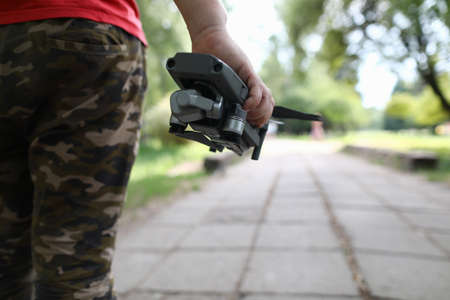 Close up of male hand holding digital gadget for taking photos high in air outsideの写真素材