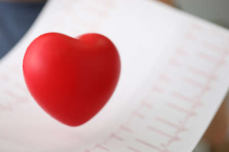 Close up of symbol of love and medicine over sheet demonstrating humanity of doctors to patientsの写真素材