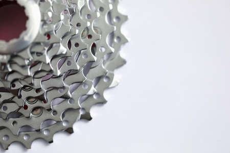 Close up of new grey toothed parts of metallic equipment isolated on white background