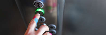 Close-up of person pressing metal knob in elevator. Dirty hand with invisible germs. Mans skin...