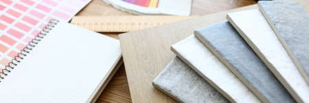 On table is color scheme and samples with color. Selection color laminate and ceramic tiles for...