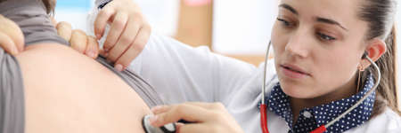 Doctor listening to patient back with stethoscope. Chronic noncommunicable diseases endanger human...
