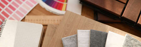 Top view of creative designer table with stuff for apartment renovation. Samples with colourful palette grey tiles ruler and notebook. Smartphone on desk. Interior design and construction conceptの写真素材
